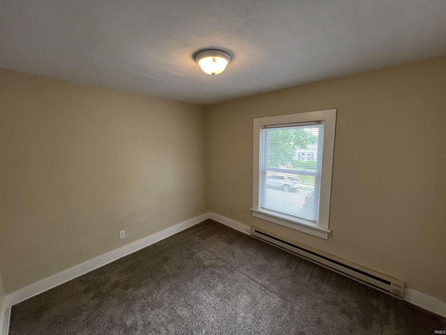 1016 Shore Dr, Fort Wayne, IN 46805 - spare room with a baseboard radiator, dark colored carpet, and baseboards