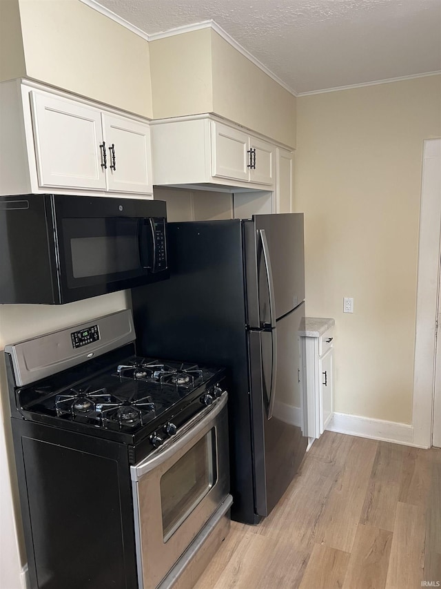 1016 Shore Dr, Fort Wayne, IN 46805 - kitchen featuring stainless steel range with gas cooktop, black microwave, light wood-style floors, white cabinets, and crown molding