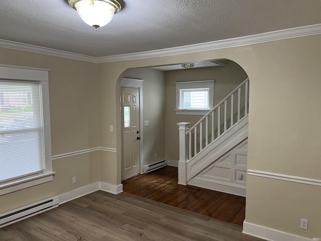 1016 Shore Dr, Fort Wayne, IN 46805 - foyer with arched walkways, baseboard heating, wood finished floors, ornamental molding, and stairs