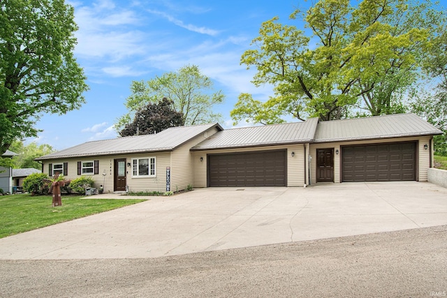 13495 N Hillside Dr, Syracuse, IN 46567 - single story home featuring a garage, driveway, metal roof, and a front yard