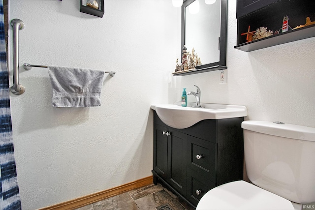 13495 N Hillside Dr, Syracuse, IN 46567 - bathroom with toilet, vanity, baseboards, and stone finish flooring