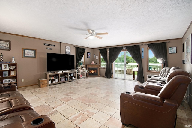 13495 N Hillside Dr, Syracuse, IN 46567 - living room featuring a ceiling fan, light tile patterned floors, crown molding, a textured ceiling, and a lit fireplace