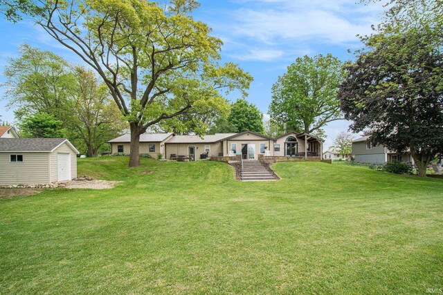 13495 N Hillside Dr, Syracuse, IN 46567 - view of green lawn with a garage and covered porch