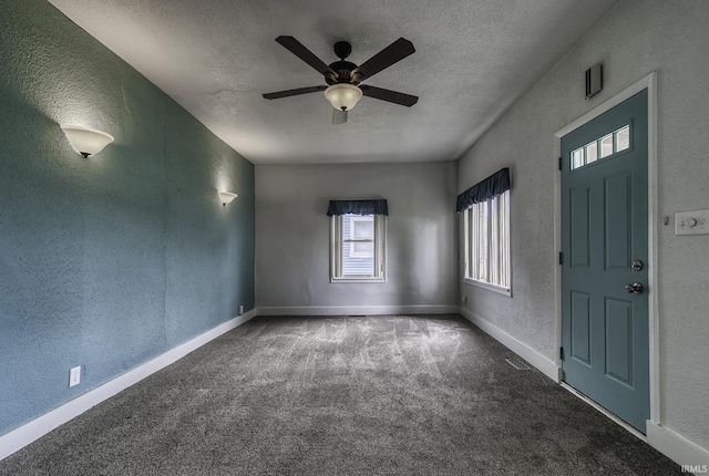 411 E Silver St, Bluffton, IN 46714 - entryway with a textured wall, a textured ceiling, plenty of natural light, a ceiling fan, and carpet floors