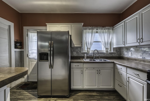 411 E Silver St, Bluffton, IN 46714 - kitchen featuring stainless steel fridge, a sink, dark countertops, ornamental molding, and decorative backsplash