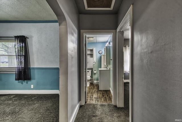 411 E Silver St, Bluffton, IN 46714 - hallway with dark colored carpet and baseboards