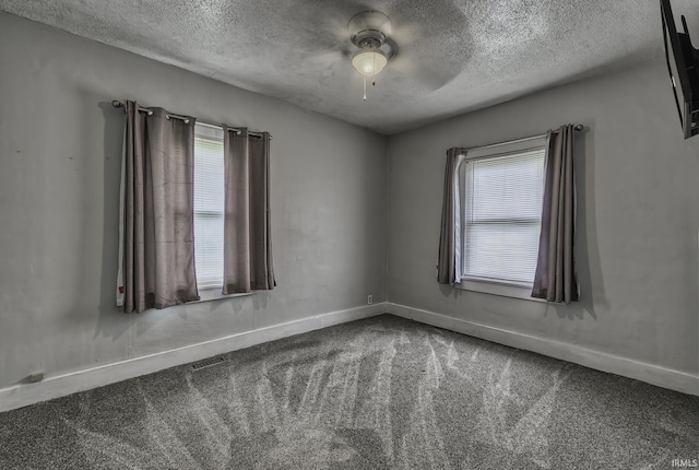 411 E Silver St, Bluffton, IN 46714 - carpeted spare room with a textured ceiling, plenty of natural light, a ceiling fan, and baseboards