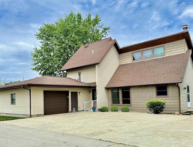 408 E Greenwalt St, North Webster, IN 46555 - view of front of house featuring a shingled roof, concrete driveway, and a garage