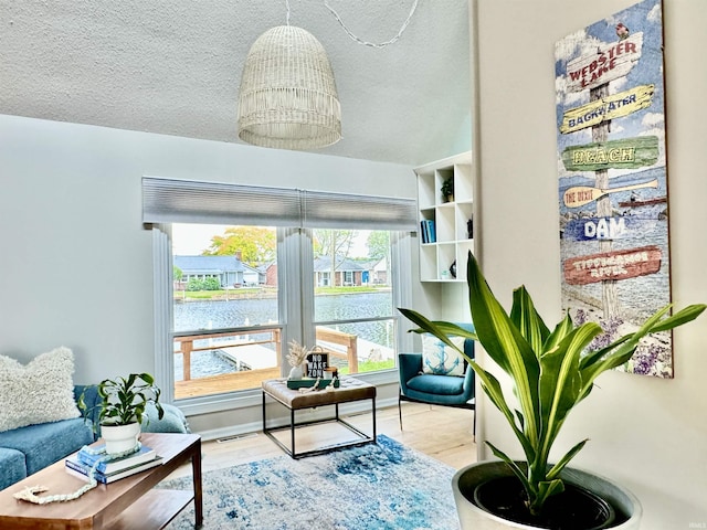 408 E Greenwalt St, North Webster, IN 46555 - living area with a water view, a textured ceiling, and wood finished floors