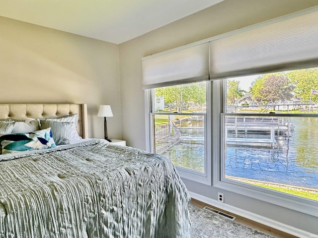 408 E Greenwalt St, North Webster, IN 46555 - bedroom with wood finished floors, baseboards, and a water view