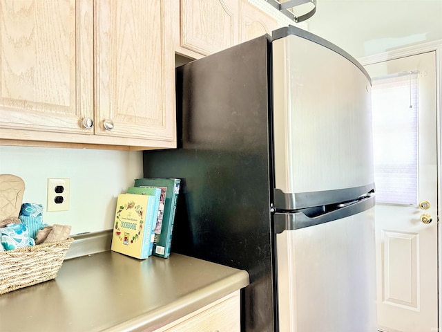 408 E Greenwalt St, North Webster, IN 46555 - kitchen with freestanding refrigerator, light countertops, and cream cabinets