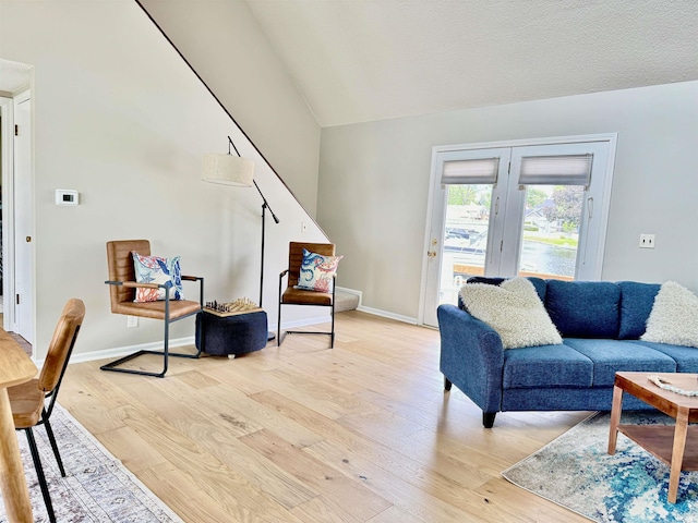 408 E Greenwalt St, North Webster, IN 46555 - living area featuring light wood finished floors, lofted ceiling, and baseboards