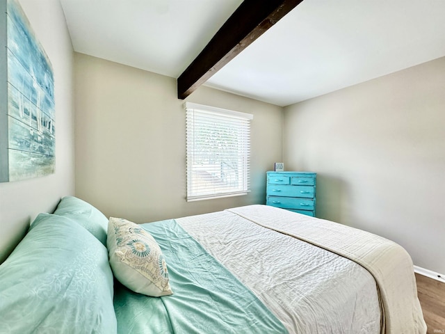 408 E Greenwalt St, North Webster, IN 46555 - bedroom featuring wood finished floors, beam ceiling, and baseboards