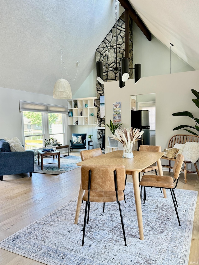 408 E Greenwalt St, North Webster, IN 46555 - dining area featuring wood finished floors, high vaulted ceiling, and beam ceiling