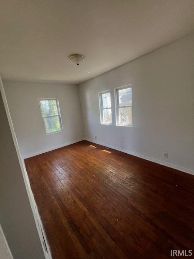1512 Marine St, South Bend, IN 46613 - spare room with dark wood-type flooring and baseboards