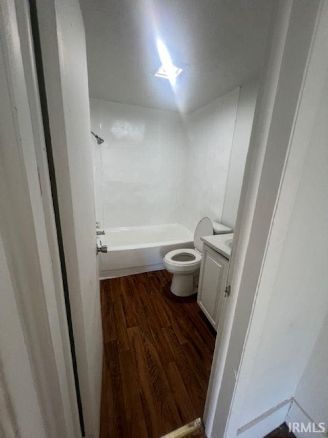 1512 Marine St, South Bend, IN 46613 - full bath with wood finished floors, vanity, toilet, and shower / washtub combination