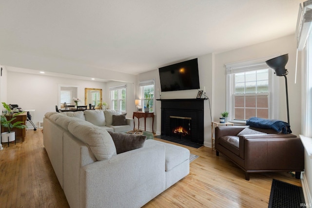 1324 Maple Ave, Fort Wayne, IN 46807 - living area featuring light wood-style flooring, a fireplace with flush hearth, recessed lighting, and baseboards