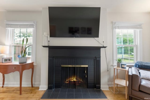 1324 Maple Ave, Fort Wayne, IN 46807 - detailed view of a fireplace with flush hearth, wood finished floors, and baseboards