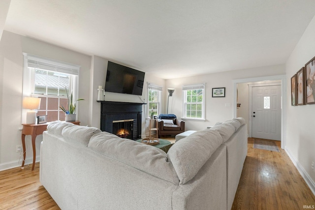 1324 Maple Ave, Fort Wayne, IN 46807 - living room with a brick fireplace, wood finished floors, and baseboards