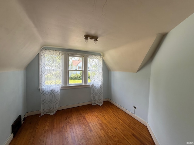502 Keller St, North Judson, IN 46366 - bonus room with wood-type flooring, lofted ceiling, and baseboards