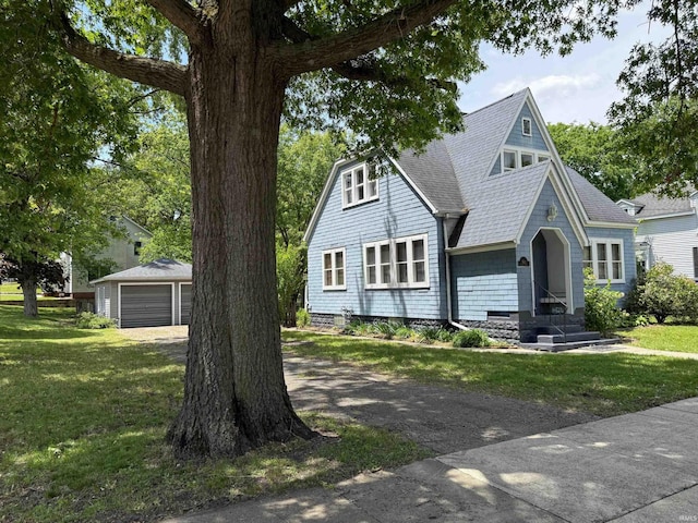502 Keller St, North Judson, IN 46366 - view of front of home featuring a garage, an outdoor structure, a front lawn, and roof with shingles