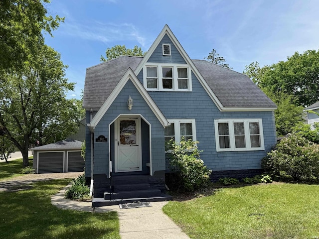 502 Keller St, North Judson, IN 46366 - view of front facade featuring a front lawn, roof with shingles, and a garage