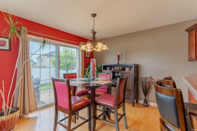 9142 Hartwell Dr, Evansville, IN 47725 - dining space with a chandelier, light wood-type flooring, and baseboards