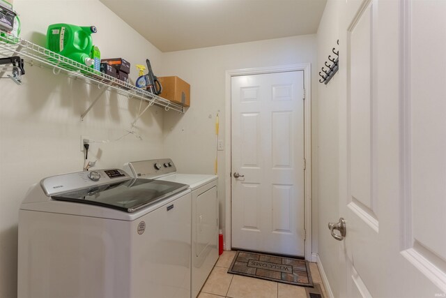 9142 Hartwell Dr, Evansville, IN 47725 - laundry room with separate washer and dryer and light tile patterned floors