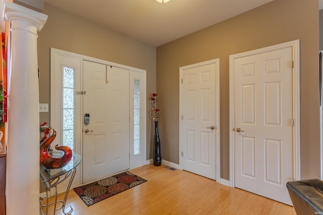 9142 Hartwell Dr, Evansville, IN 47725 - entrance foyer featuring light wood finished floors, decorative columns, and baseboards