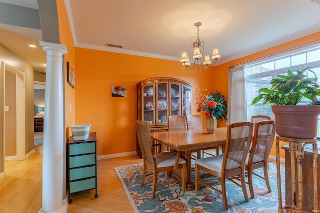 9142 Hartwell Dr, Evansville, IN 47725 - dining room featuring ornamental molding, light wood-style flooring, a chandelier, ornate columns, and baseboards