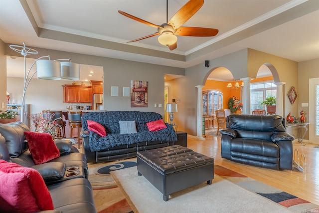 9142 Hartwell Dr, Evansville, IN 47725 - living area featuring ornate columns, arched walkways, ceiling fan, a raised ceiling, and crown molding