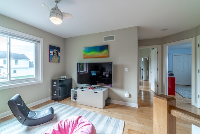 3513 Crater Cv, Fort Wayne, IN 46804 - living room with baseboards, light wood finished floors, and ceiling fan