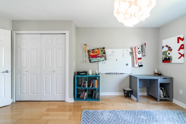 3513 Crater Cv, Fort Wayne, IN 46804 - bedroom with a chandelier, light wood-style floors, a closet, and baseboards