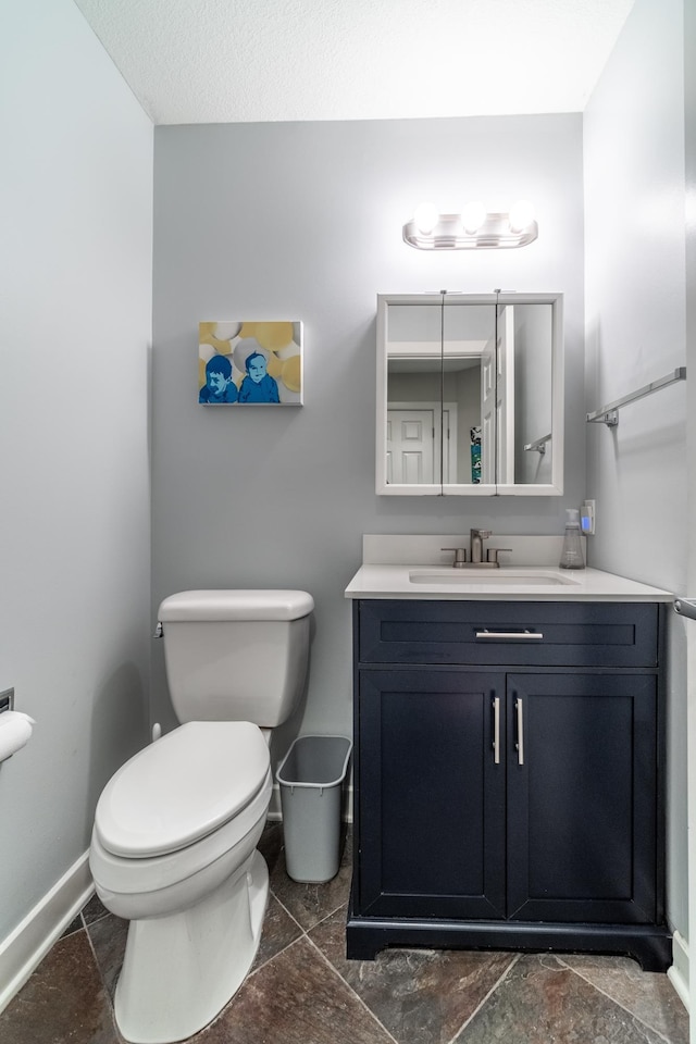 3513 Crater Cv, Fort Wayne, IN 46804 - half bathroom with toilet, vanity, baseboards, and stone finish flooring