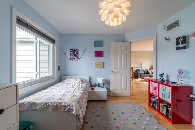 3513 Crater Cv, Fort Wayne, IN 46804 - bedroom with a chandelier and wood finished floors
