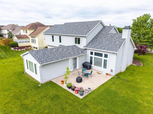 3513 Crater Cv, Fort Wayne, IN 46804 - rear view of house with roof with shingles, a chimney, a lawn, and a patio