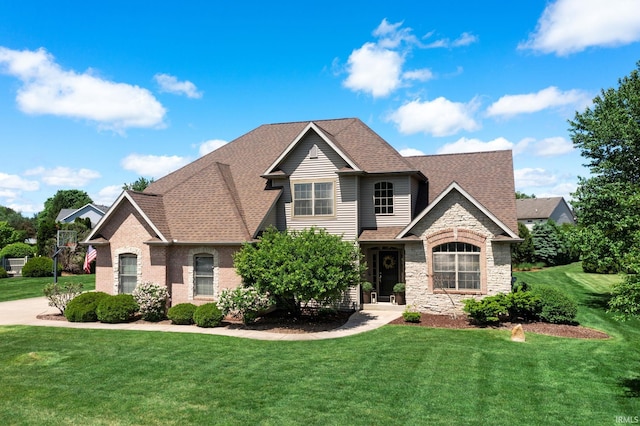 14433 Sedgwick Dr, Granger, IN 46530 - view of front of home with a front lawn, stone siding, and a shingled roof