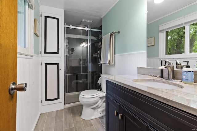 1875 N Michael Dr, Marion, IN 46952 - bathroom featuring vanity, a stall shower, toilet, ornamental molding, and a wainscoted wall