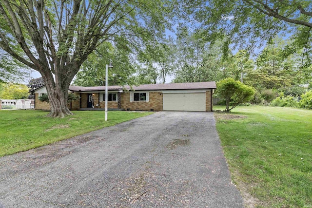 1875 N Michael Dr, Marion, IN 46952 - single story home featuring an attached garage, asphalt driveway, a front yard, and brick siding