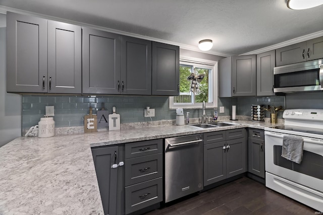 1875 N Michael Dr, Marion, IN 46952 - kitchen with stainless steel appliances, a sink, ornamental molding, backsplash, and dark wood finished floors