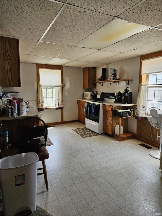 115 High St, Geneva, IN 46740 - kitchen featuring electric range oven, open shelves, light flooring, a drop ceiling, and light countertops