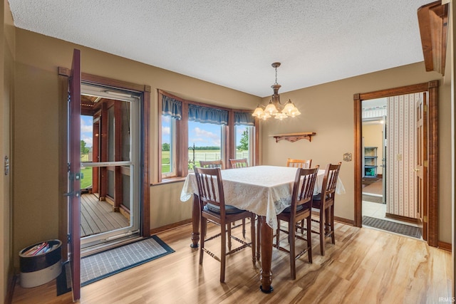 7800 E 400 S-92, Fort Wayne, IN 46818 - dining space featuring a chandelier, light wood-style floors, a textured ceiling, and baseboards