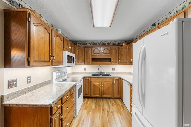 7800 E 400 S-92, Fort Wayne, IN 46818 - kitchen with white appliances, a sink, brown cabinetry, and light wood-style floors