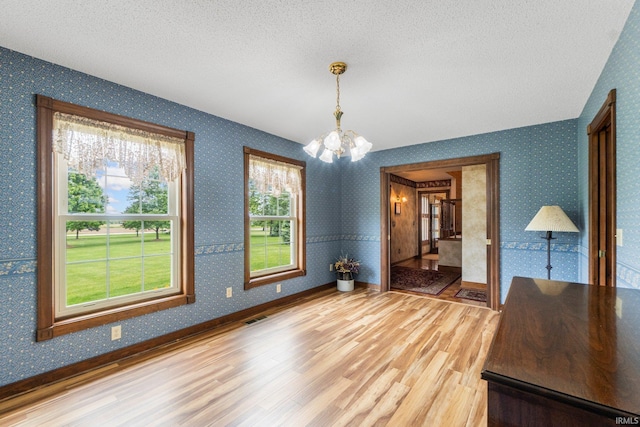 7800 E 400 S-92, Fort Wayne, IN 46818 - unfurnished dining area featuring a chandelier, light wood-style floors, a textured ceiling, baseboards, and wallpapered walls
