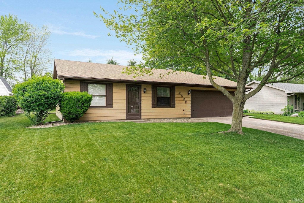 2520 Repton Dr, Fort Wayne, IN 46815 - ranch-style home with driveway, an attached garage, and a front lawn