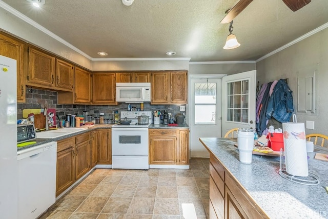 718 Center St, New Haven, IN 46774 - kitchen featuring white appliances, a sink, brown cabinetry, decorative backsplash, and ornamental molding