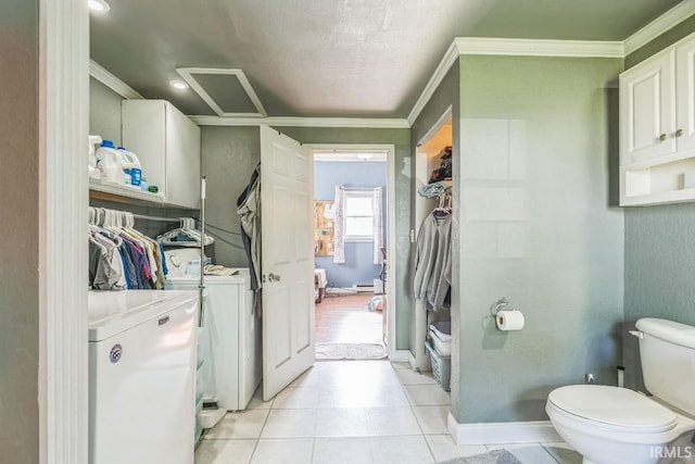 718 Center St, New Haven, IN 46774 - bathroom featuring washing machine and dryer, ornamental molding, toilet, tile patterned flooring, and baseboards