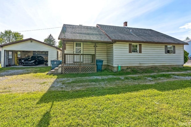 718 Center St, New Haven, IN 46774 - rear view of property featuring a lawn, an outbuilding, a porch, and a shingled roof