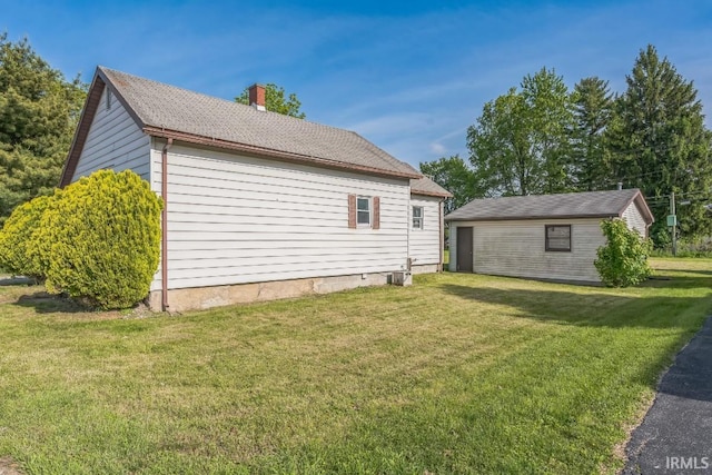 718 Center St, New Haven, IN 46774 - view of home's exterior featuring a chimney and a yard