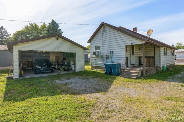 718 Center St, New Haven, IN 46774 - back of property featuring an outdoor structure, a detached garage, and a lawn